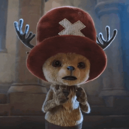a stuffed animal wearing a red hat with an x on it and antlers