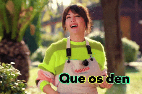 a woman wearing a neon green sweater and white apron is laughing with the words que os den below her