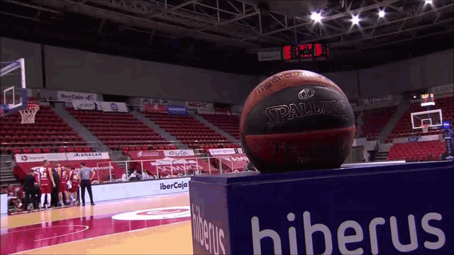 a spalding basketball is sitting on top of a cube with hiberus written on it