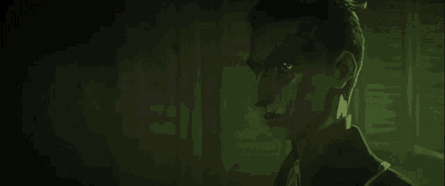 a close up of a man 's face in a dark room .