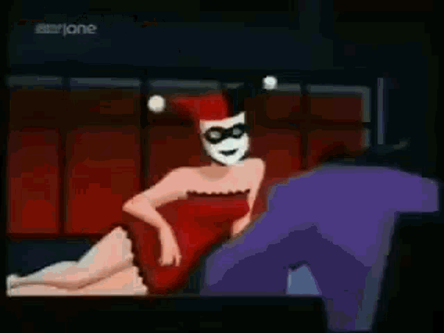harley quinn and the joker are sitting at a table looking at papers