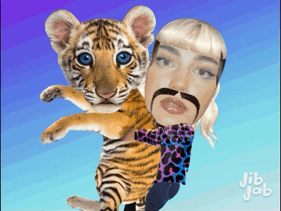 a woman with a mustache holds a tiger cub