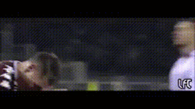 a blurry picture of a man with the letter c on the bottom left