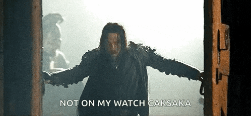 a man is standing in a doorway with his arms outstretched and a caption that says `` not on my watch '' .