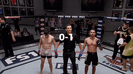 a referee stands between two fighters in a boxing ring with the score 0-1