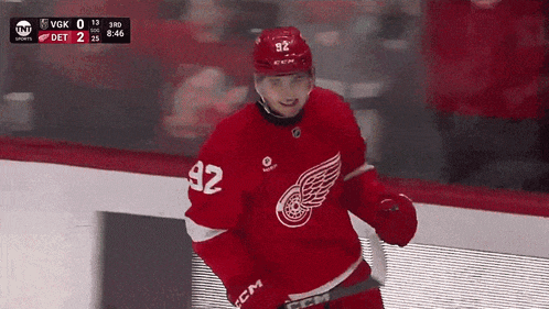 a hockey player wearing a red jersey with 92 on it