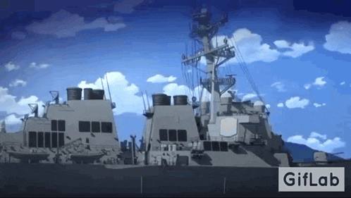 a large military ship with a blue sky and clouds in the background .
