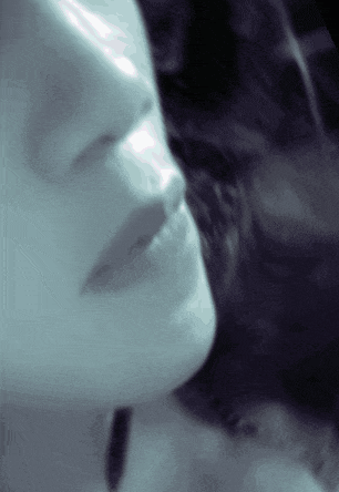 a close up of a woman 's face in a blue tone