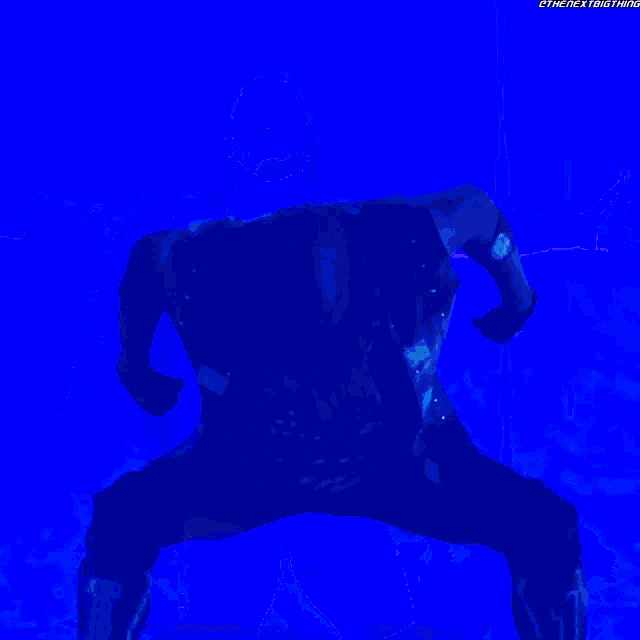 a man in a black shirt with the number 11 on it stands in a blue light