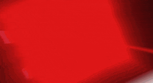 a red light is shining through a dark room