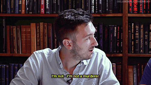 a man says i 'm not i 'm not a murderer in front of a bookshelf full of books