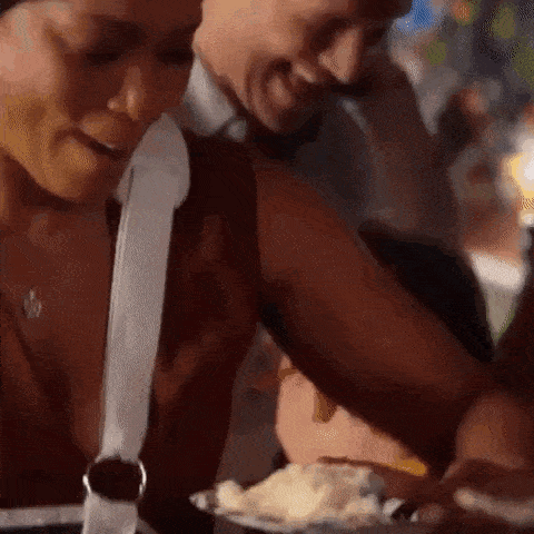 a man and a woman are eating ice cream together at a restaurant .