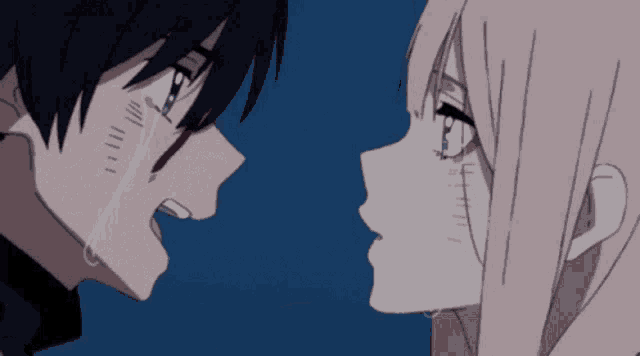 a man and a woman are looking at each other with tears coming down their faces