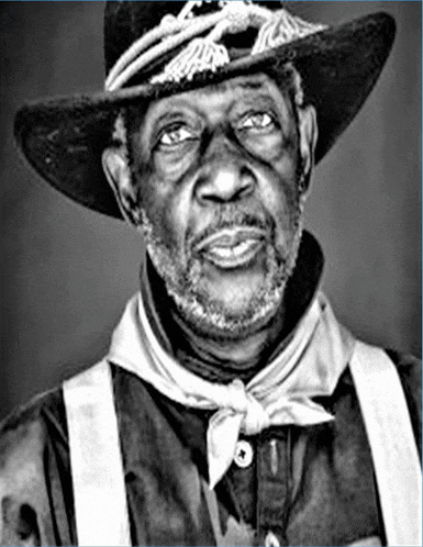 a black and white photo of an older man wearing a cowboy hat