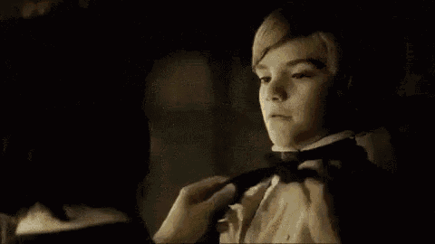 a man and a boy are standing next to each other in front of a mirror .
