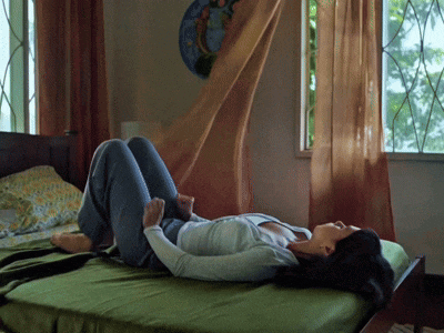 a woman laying on her stomach on a bed