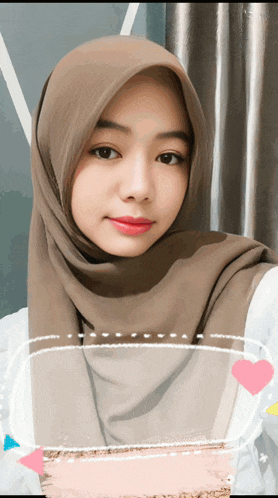 a woman wearing a hijab looks at the camera with a heart in the corner