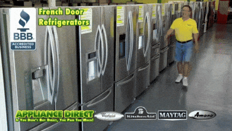 a man in a yellow shirt is standing in front of a row of refrigerators