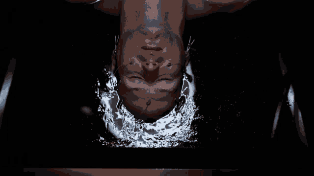 a man is upside down with his eyes closed