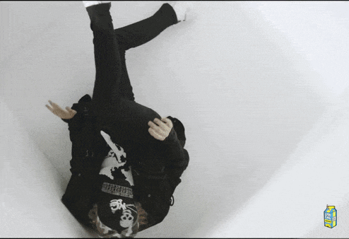 a person laying on their back with a lychee juice carton next to them