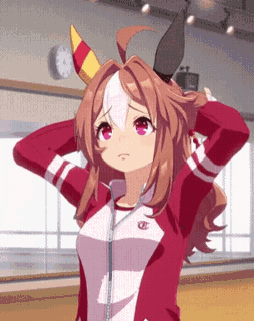 a girl in a red jacket with the letter t on her chest