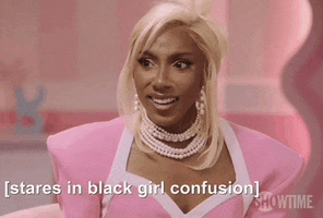 a woman in a pink dress and pearls is talking about being a black girl confusion .