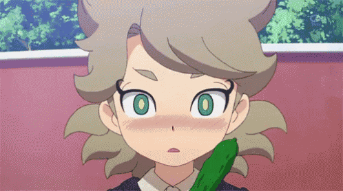 a close up of a cartoon character holding a cucumber in his mouth .
