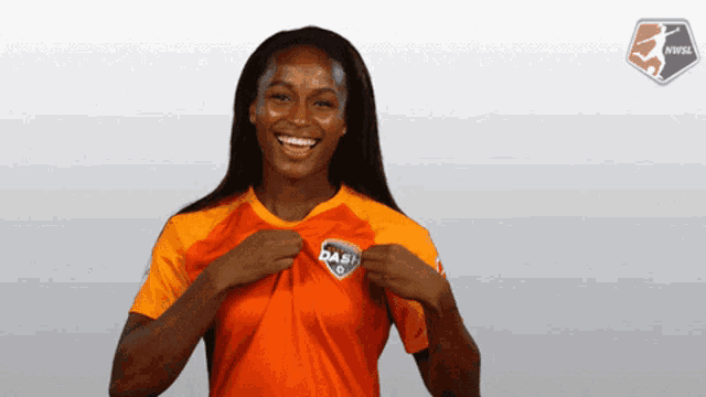 a woman wearing an orange shirt that says dash is smiling