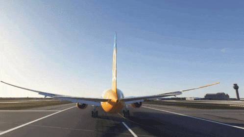 a yellow and blue airplane is on the runway