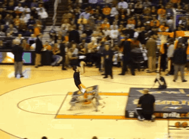 a basketball game is being played in front of a crowd and a sign that says ' gatorade ' on it