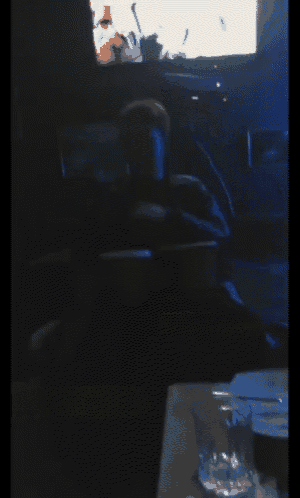 a blurry picture of a person sitting in a dark room