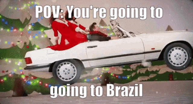 a woman in a santa suit is driving a white car