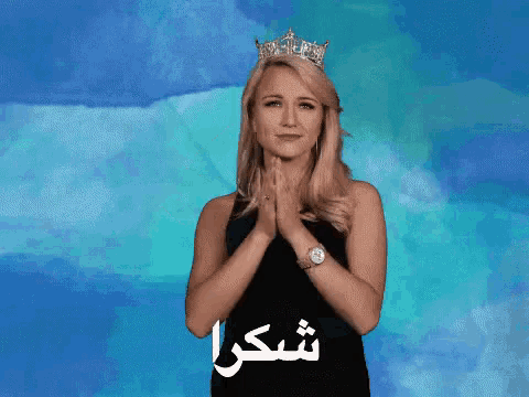 a woman wearing a crown is covering her mouth