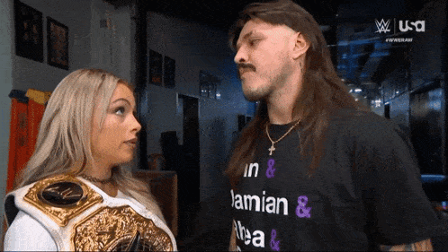 a man and a woman are looking at each other and the man is wearing a shirt that says " in & lamian & tea "