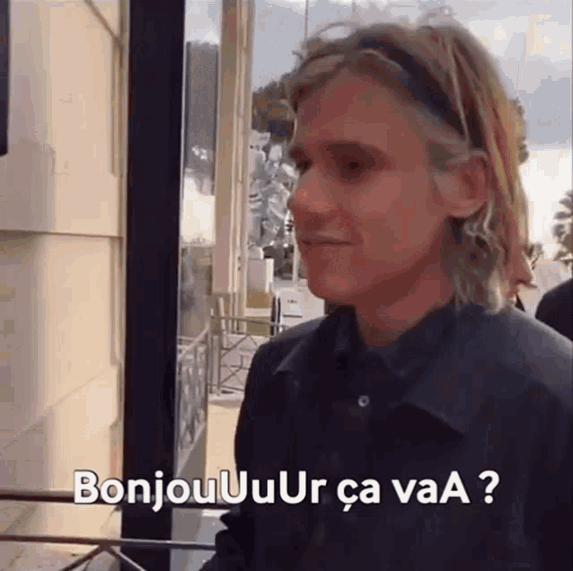 a man with a headband on his head says bonjour ur ca vaa