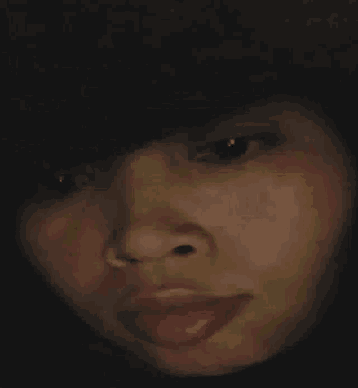 a close up of a woman 's face with her mouth open