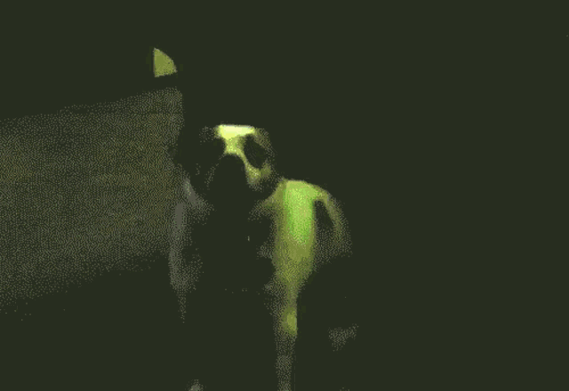 a man is standing in front of a green laser beam .
