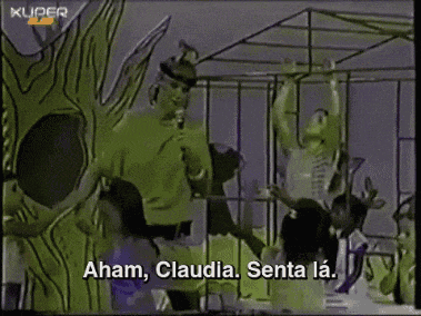 a group of people are standing in a cage with the words " aham claudia senta la " on the bottom right
