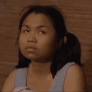 a young woman with pigtails is making a funny face while looking up .