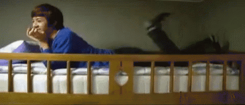 a person is laying on a bunk bed with their feet up