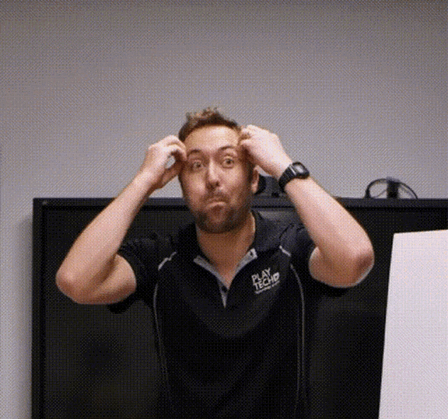 a man wearing a black shirt that says play tech