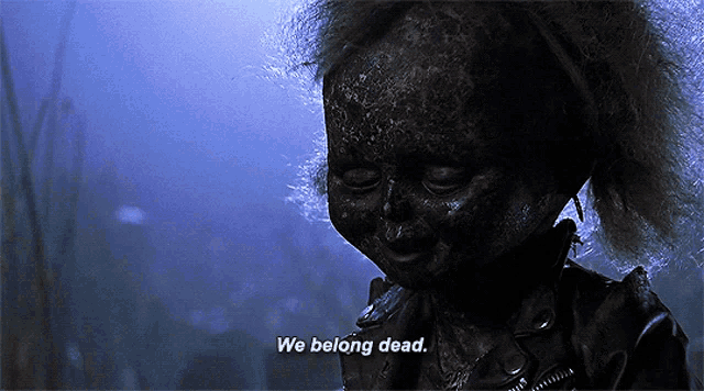 a doll says we belong dead in a dark scene