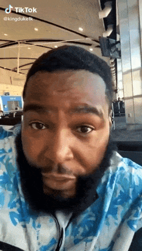 a man with a beard is wearing headphones and looking at the camera