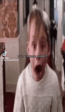 a young boy with his mouth open and the words " are u home alone " on the bottom