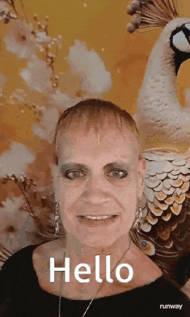 a woman is standing in front of a peacock and saying hello