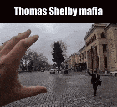 a thomas shelby mafia poster shows a man walking down the street