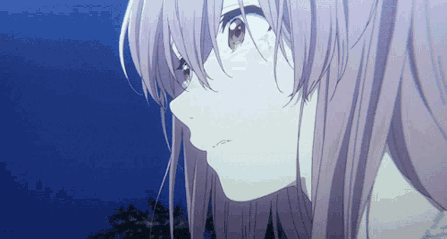 a close up of a girl 's face with a blue sky in the background