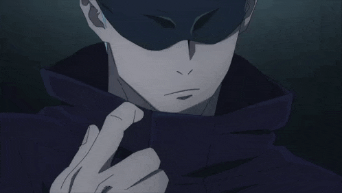 a close up of a person wearing a mask and covering their face with their hand .