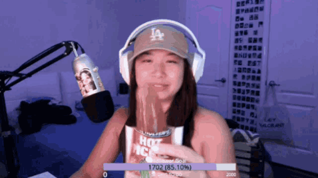 a girl wearing a la hat is eating a hot rice