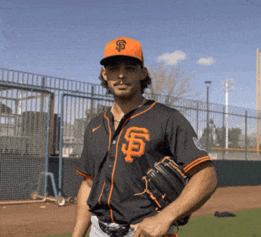 a baseball player wearing a black and orange jersey with the letter s on it